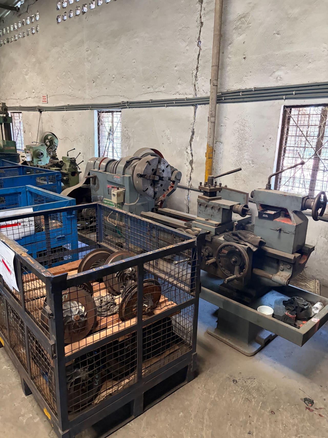 Conventional centre lathe with parts in crate