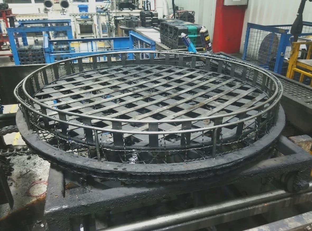 Large fabricated stainless steel basket bin for a shot-blasting machine